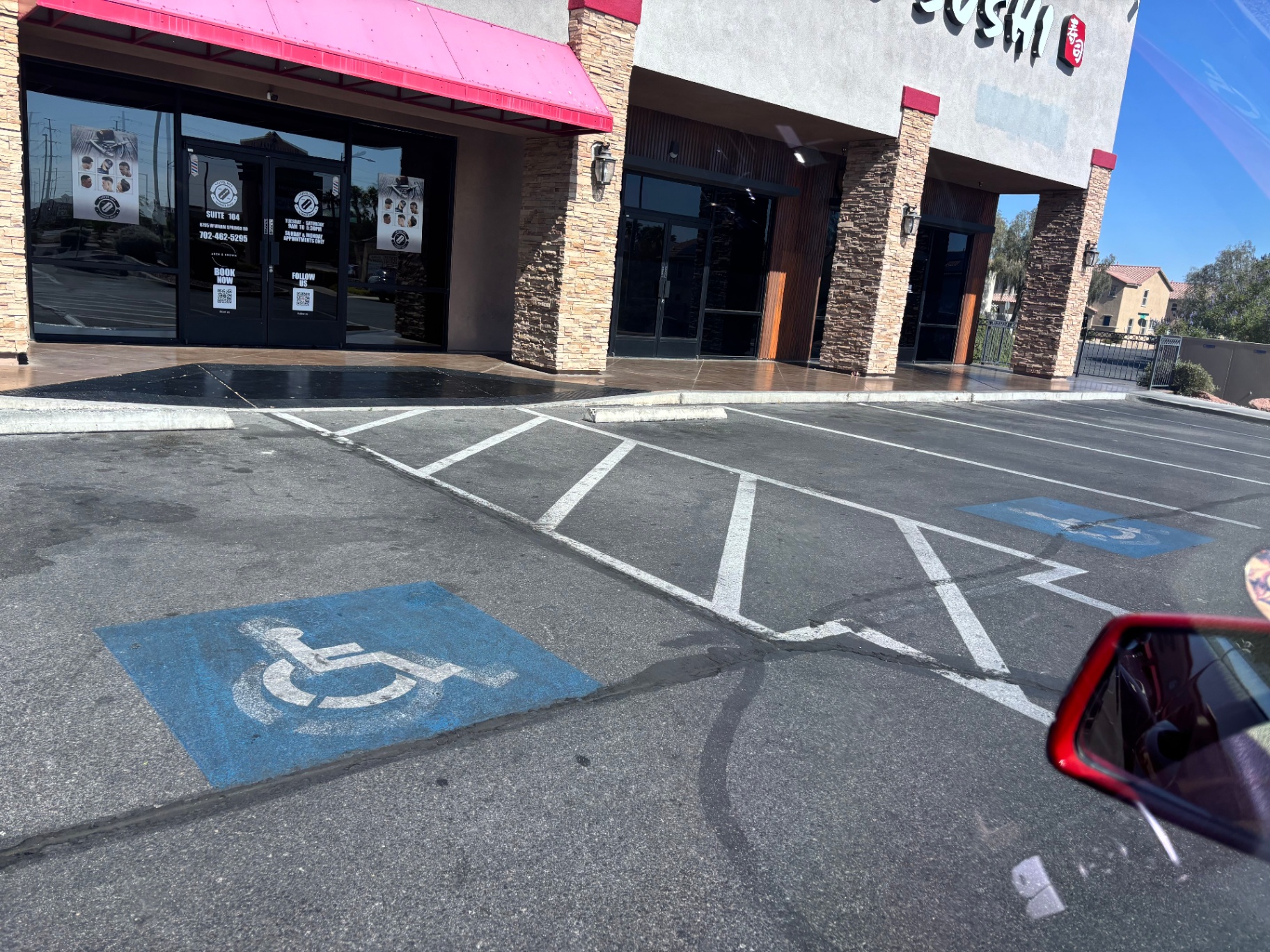Faded blue accessible parking stalls in a shopping center lot
